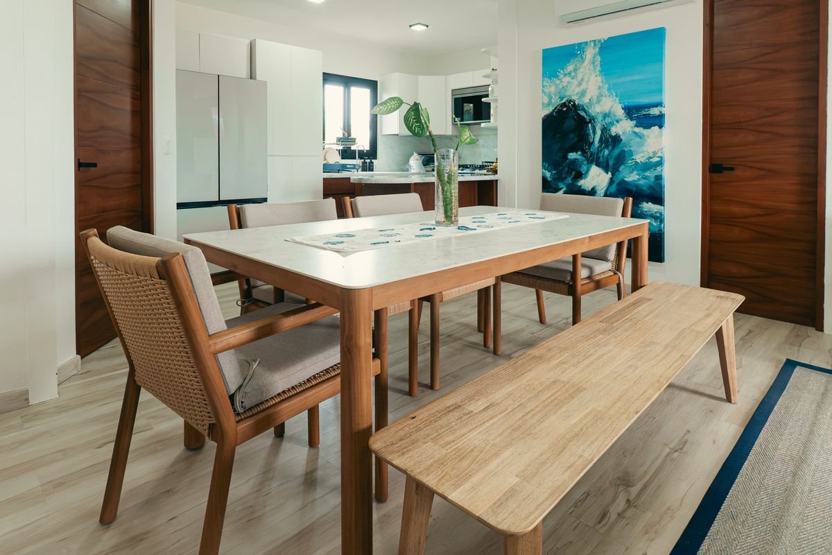 Comedor con banca de madera y sillas tejidas