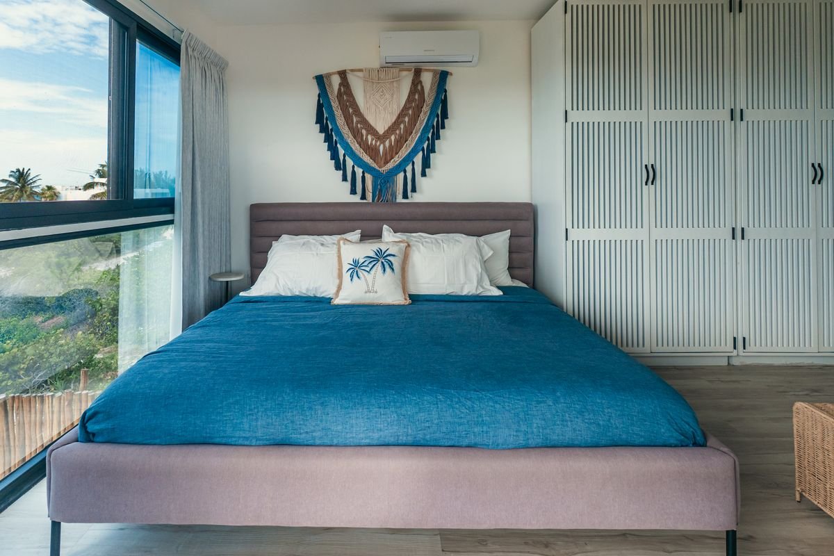 Habitación principal con cama king y ventanal con vista